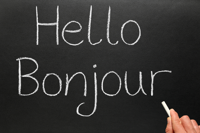 Bonjour, hello in French written on a blackboard.